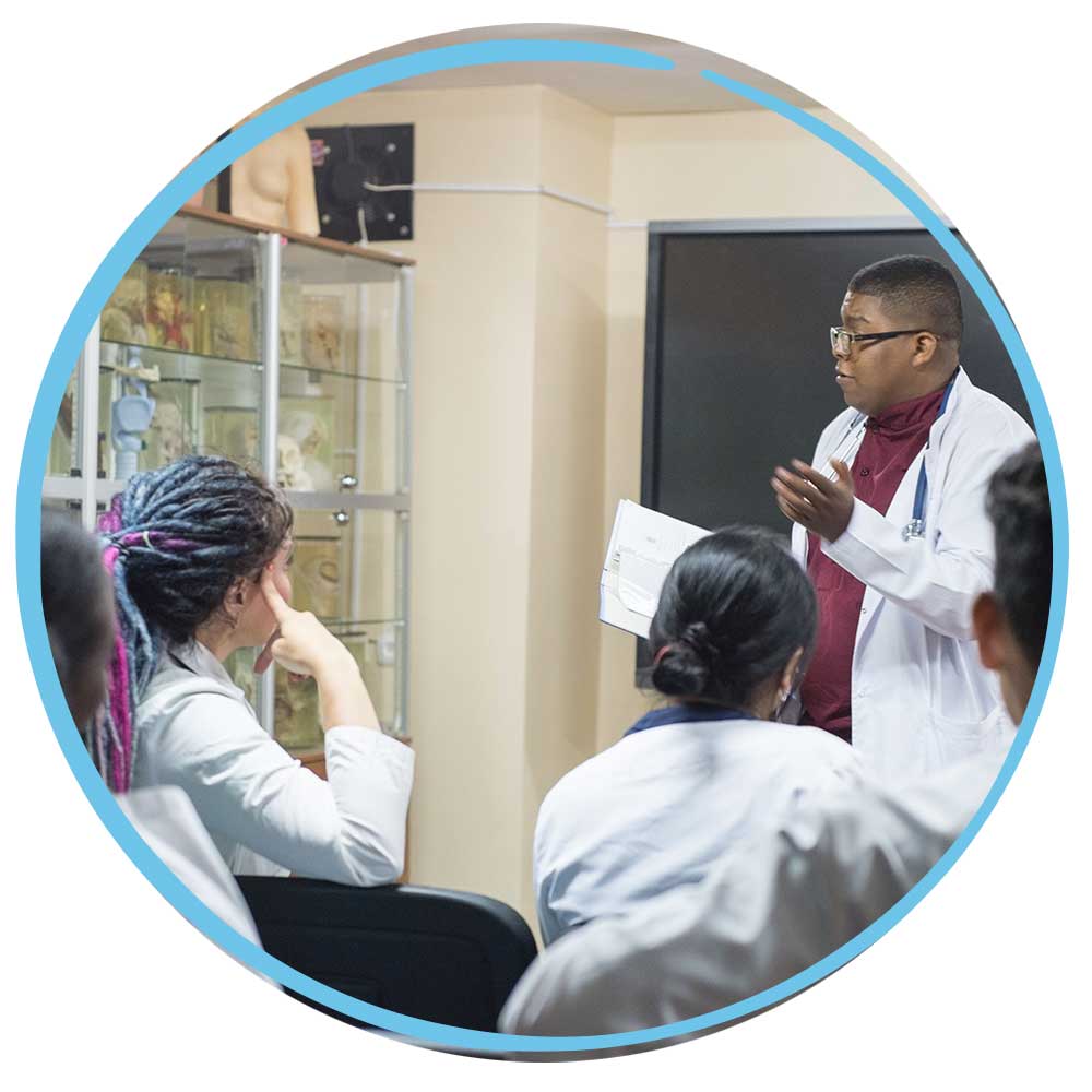 Teacher in front of diverse class wearing lab coat
